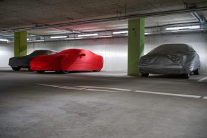 Covered luxury cars in the garage